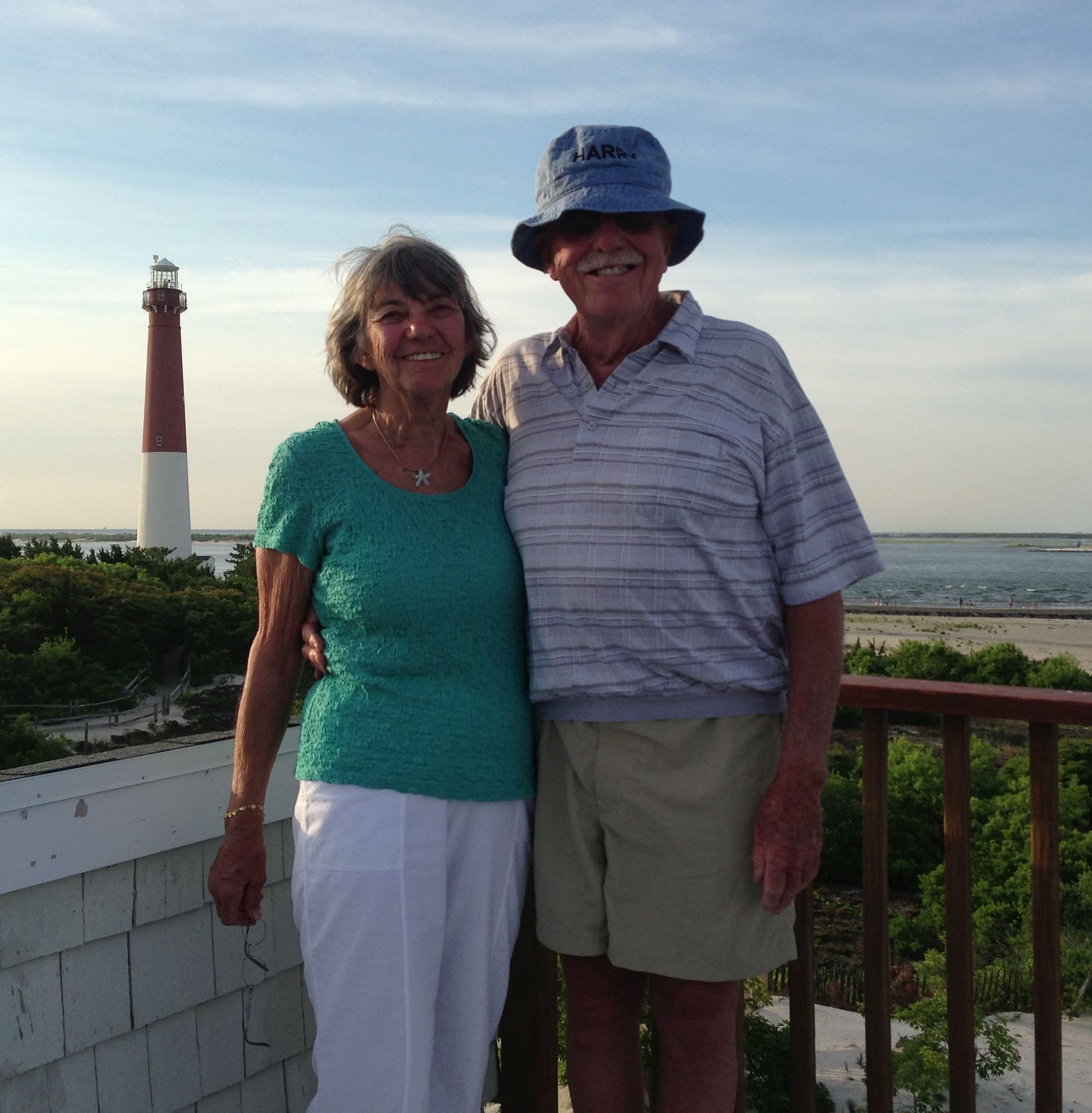 Harry and Mary smiling together in front of a lighthouse