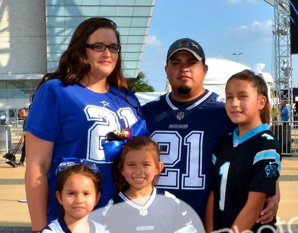 Katy and Moises Argueda with their daughters wearing Dallas Cowboys and Carolina Panthers jerseys