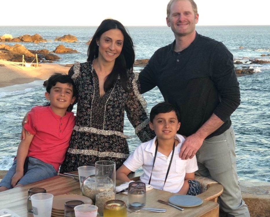 Jenine D with her husband and sons about to eat dinner by the water