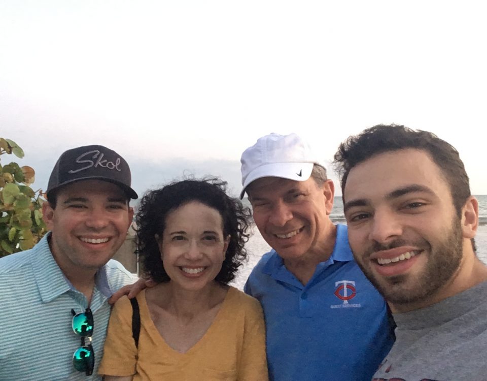 Barry Kelner with his wife and sons at the beach wearing Minnesota Twins guest services polo