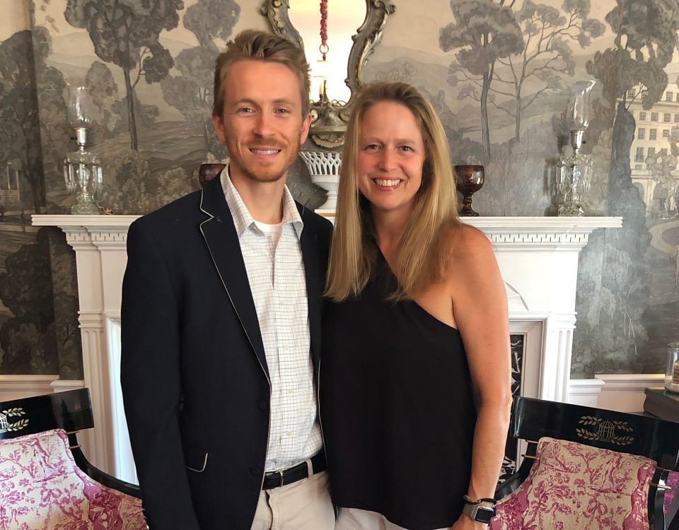 Meade Lane and her husband in front of a white granite fireplace