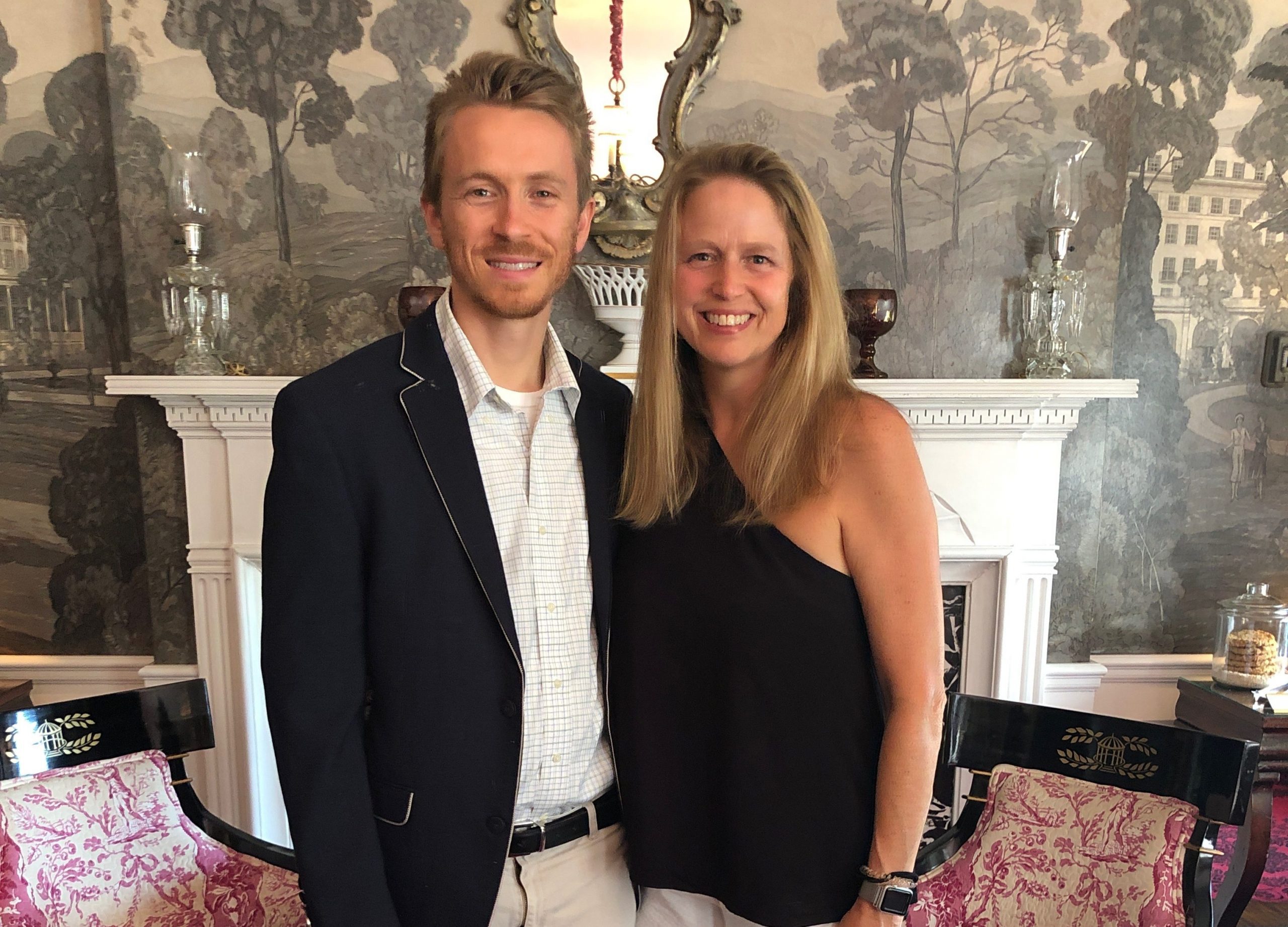 Meade Lane and her husband in front of a white granite fireplace