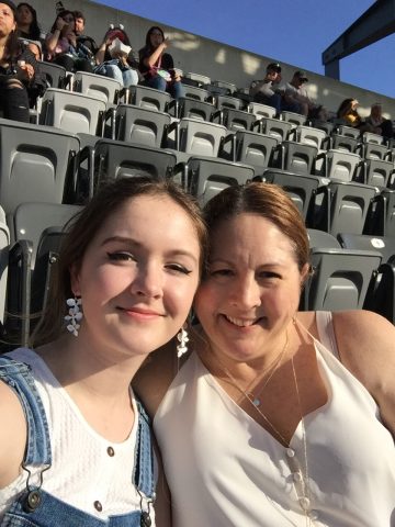 Kristin Wallace and daughter sitting in their seats waiting for the event to start