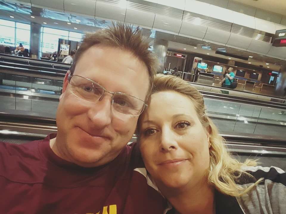 Elizabeth and Chad at the airport in front of travelator