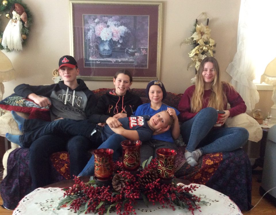 the davidson kids sitting on the couch together