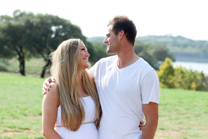 Shelby and Dustin looking deep into each other's eyes wearing white clothing