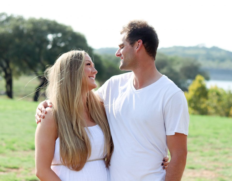 Shelby and Dustin looking deep into each other's eyes wearing white clothing