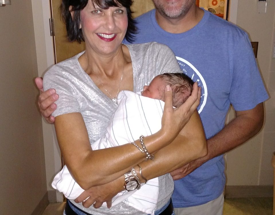 Patti Beaudoin with husband holding newborn baby in the hospital