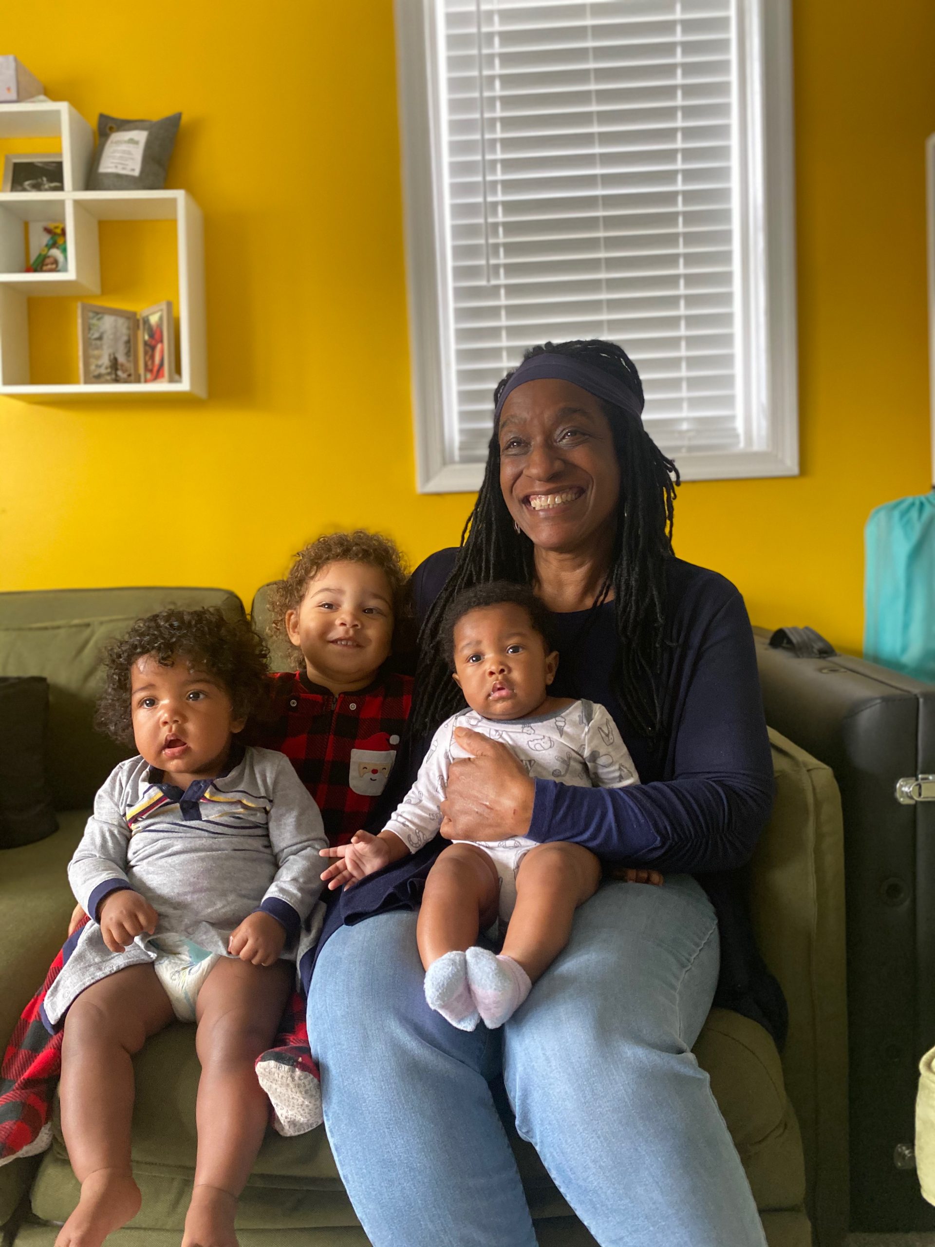 Carole Campbell with the three kids on the couch