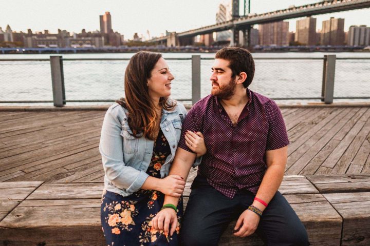 Josh Terc and Dallis Vargas looking into each other's eyes with the city in the background