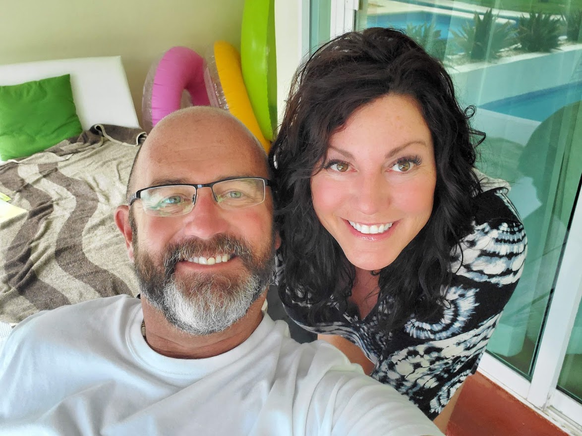 justin and kimberly tate on the porch with inter tubes behind them