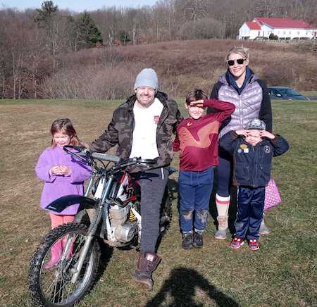 The Oertels hanging out in the yard around Justin's dirtbike