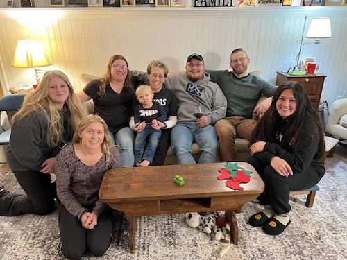 Ruth Anne Frey with a bunch of her family hanging around the coffee table