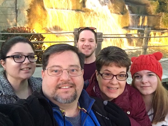 Robbi Muckenfuss with her family in front of a waterfall and bridge