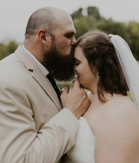 Eric kissing Tiphani on the forehead on their wedding day