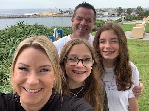 The Traftons all smiles by the water