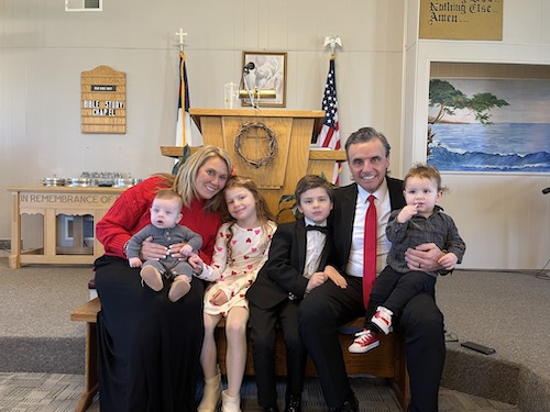 Aimee Morton with her family at church in front of the pulpit