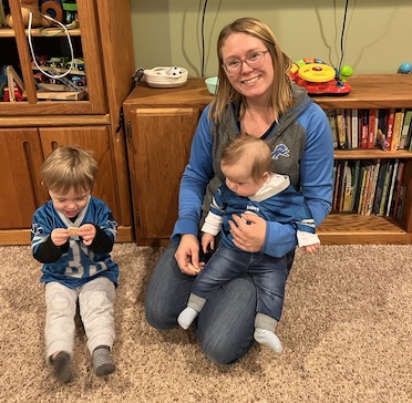 Caroline Fullerton with her kids all wearing Detroit Lions football gear