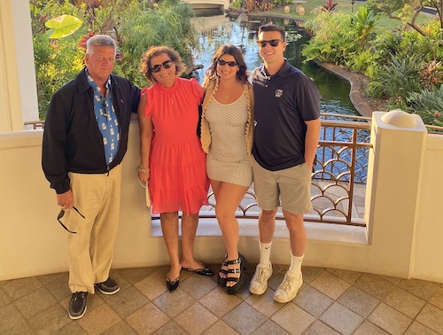 Cindy Sestito with her husband and children rocking shades with a pond in the background