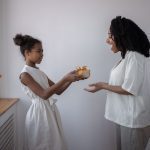 a happy mom receiving personalized gifts from her daughter