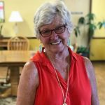 Alice Metcalfe smiling in a bright orange shirt