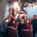 sparklers and champagne being held during a wedding reception celebration