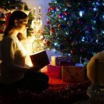 woman looking at a special gift in the darkness during Christmastime