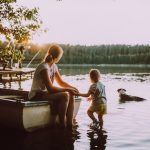 Mother and son in the lake with their dog