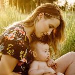 Mother in the grass with her baby boy