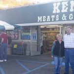 Kent and Kathy Pfrimmer in front of Kent's Meat & Groceries