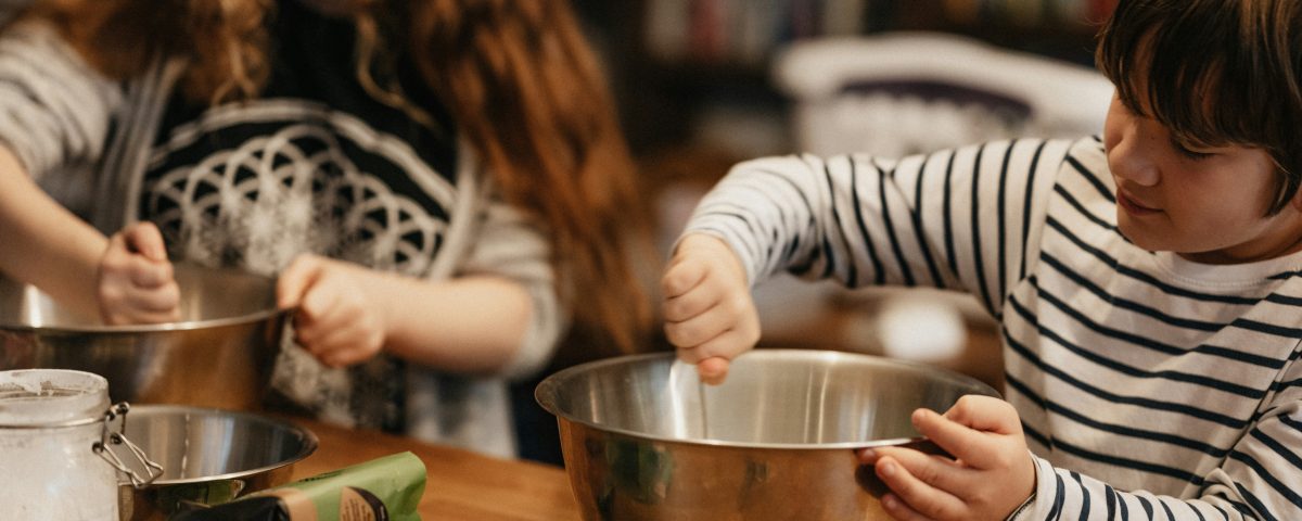 son cooking with Mom in the kitchen