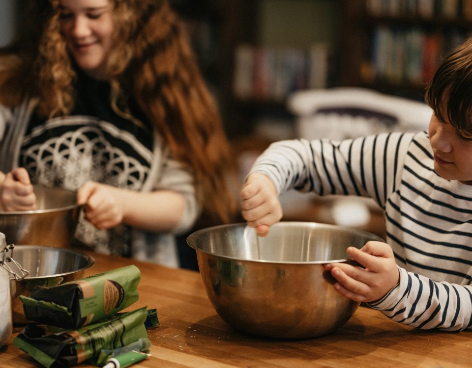 son cooking with Mom in the kitchen